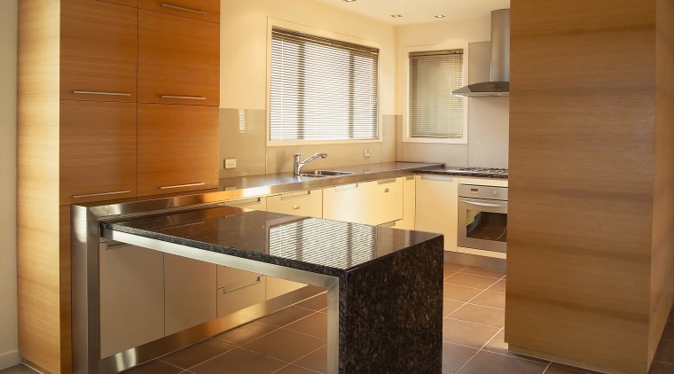 A view of a kitchen area, black tiled cabinetry, countertop, cuisine classique, floor, flooring, interior design, kitchen, real estate, room, brown, orange