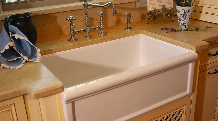 view of this bathroom area showing timber cabinetry, bathroom, bathroom accessory, bathroom cabinet, cabinetry, countertop, floor, flooring, furniture, kitchen, plumbing fixture, room, sink, brown, orange
