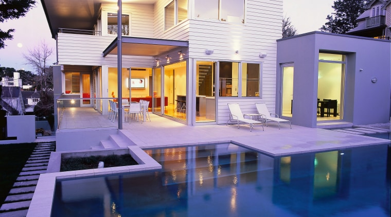 Exterior view of white two-storey weatherboard house with apartment, architecture, building, elevation, estate, facade, home, house, interior design, lighting, property, real estate, reflection, residential area, swimming pool, villa, window, blue, white