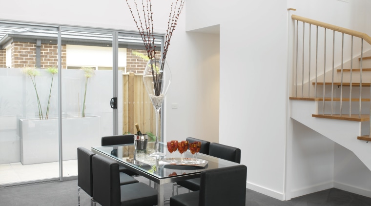 Dining room area with grey flooring, white walls, architecture, floor, flooring, furniture, hardwood, interior design, laminate flooring, loft, product design, table, tile, wall, wood, wood flooring, white, gray