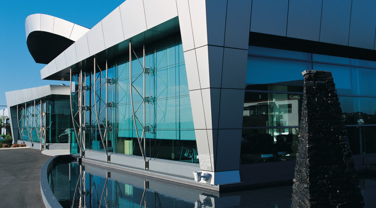 Exterior view of building showing large windows and architecture, building, commercial building, corporate headquarters, facade, headquarters, metropolitan area, reflection, sky, structure, black, teal