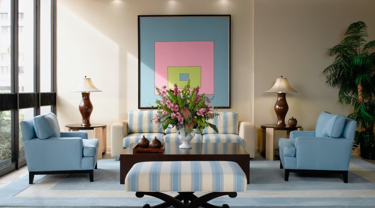 view of sthe lobby featuring pale blue furniture ceiling, furniture, interior design, living room, lobby, room, table, wall, gray