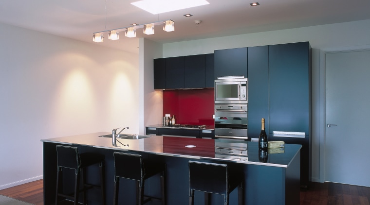 Apartment kitchen with blue cabinetry, stainless steel benchtop ceiling, countertop, floor, interior design, kitchen, real estate, room, table, gray, black