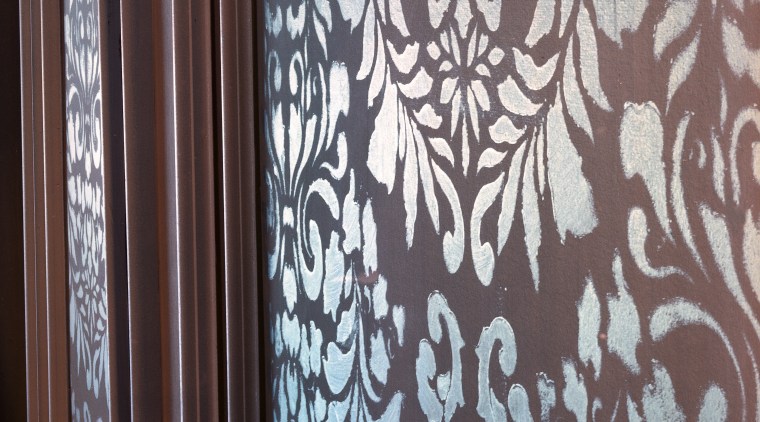 Closeup of stencilling on wall panel. - Closeup curtain, design, interior design, pattern, textile, wall, wallpaper, wood, gray, black