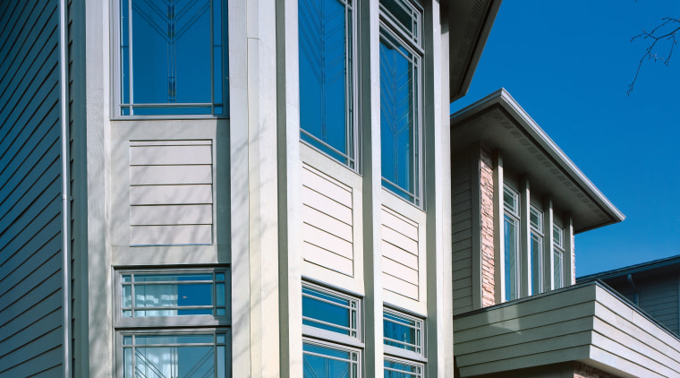Exterior view of apartment showing patterned glass windows. architecture, building, commercial building, elevation, facade, home, house, property, real estate, residential area, sash window, siding, structure, window, gray, black