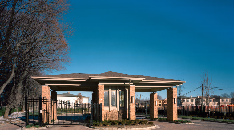 Guard house of residential community with wrought iron architecture, building, home, house, property, real estate, residential area, shed, sky, suburb, blue