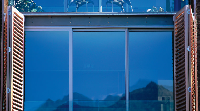 Large window with aluminium joinery and timber shutters. blue, glass, sky, window, blue