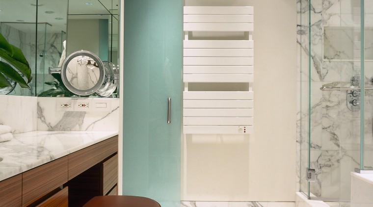 view of this bathroom featuring marble vein walls,floor bathroom, bathroom accessory, door, floor, flooring, glass, home, interior design, room, tile, white, gray