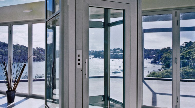 View of small elevator with glass door and door, glass, window, gray, white