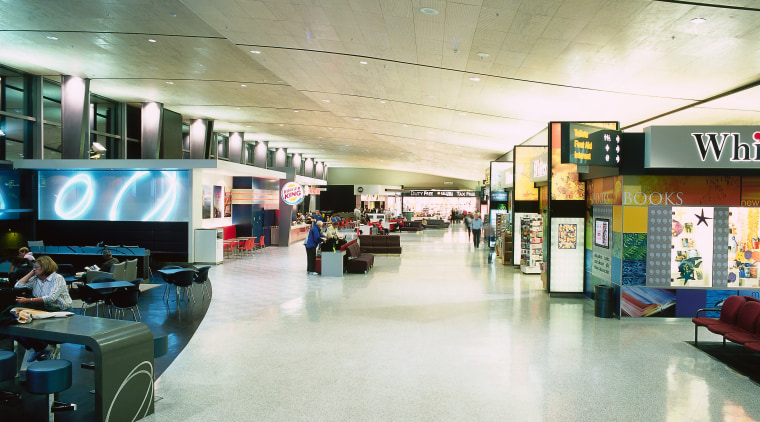 Central walkway through airport with rubber flooring. airport terminal, interior design, retail, shopping mall, white