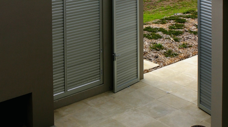 A view of some outdoor tiling. - A architecture, floor, flooring, home, house, property, real estate, tile, wall, gray, black