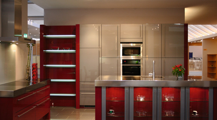 Kitchen with red cabinetry and shelving, stainless steel cabinetry, countertop, furniture, interior design, kitchen, room, shelving, brown, red