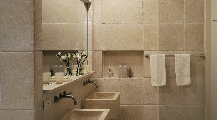 View of this bathroom featuring two seater bathtub, architecture, bathroom, floor, flooring, interior design, plumbing fixture, room, sink, tile, wall, brown, orange