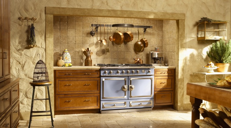 Traditional style kitchen with wood cabinetry, stone walls cabinetry, countertop, cuisine classique, furniture, interior design, kitchen, room, brown, orange