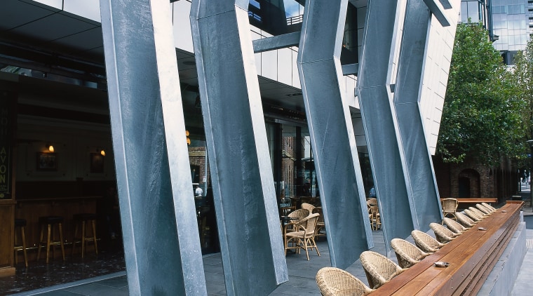 view of the outdoor seating area featuring large architecture, building, condominium, structure, teal