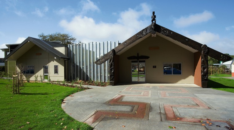 An exterior view of the health centre. - cottage, estate, facade, grass, home, house, landscape, property, real estate, residential area, sky, villa, teal