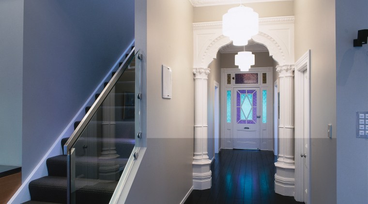 view of the renovated hallway featuring dark stained architecture, ceiling, daylighting, floor, handrail, home, interior design, property, real estate, stairs, structure, blue