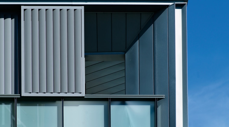 Exterior view of apartment building showing metal titanium architecture, building, commercial building, daylighting, elevation, facade, home, house, line, residential area, roof, siding, sky, window