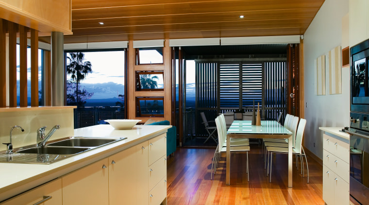 view of the kitchen featuring timber flooring, frosted countertop, interior design, kitchen, real estate, wood, brown, orange