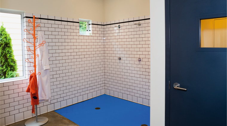 view of this bathroom featuring subway tiles on architecture, bathroom, floor, flooring, house, interior design, room, tile, wall, gray, blue