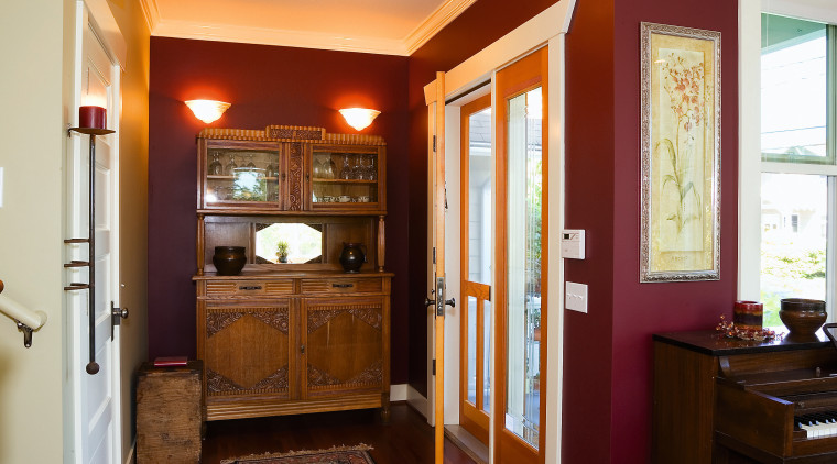 A view of a wooden display unit, wooden ceiling, dining room, door, floor, flooring, hardwood, home, house, interior design, laminate flooring, living room, real estate, room, wall, window, wood, wood flooring, wood stain, red