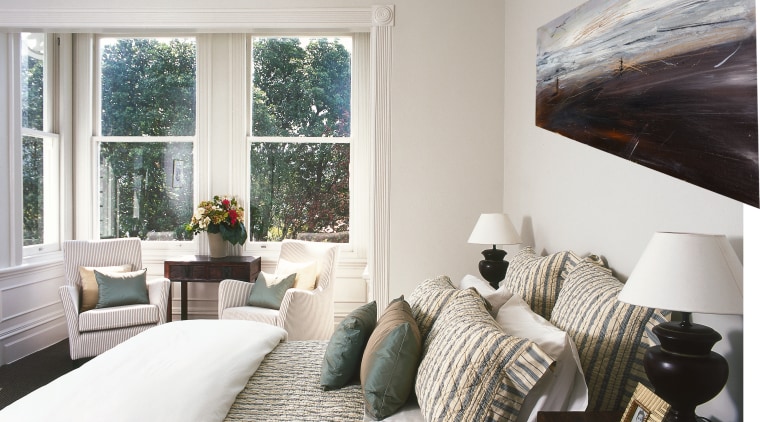A view of a bedroom, white walls, artwork, bed frame, bedroom, ceiling, daylighting, floor, home, house, interior design, living room, property, real estate, room, wall, window, white