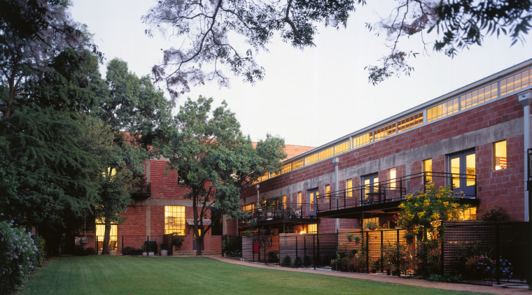 An exterior view of the old glass factories architecture, building, campus, city, corporate headquarters, estate, facade, grass, home, house, mixed use, plant, property, real estate, residential area, tree, white, black