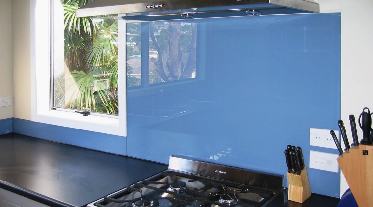 A view of a glass splashback by Glass countertop, glass, home appliance, interior design, kitchen, room, window, teal