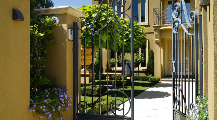 A view of this  Mediteranean style house courtyard, estate, facade, fence, gate, home, house, neighbourhood, outdoor structure, property, real estate, residential area, brown