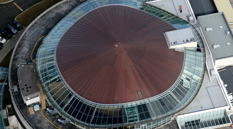 View of the oval copper and glass roof aerial photography, arena, bird's eye view, building, daylighting, sport venue, stadium, structure, urban area, black, gray