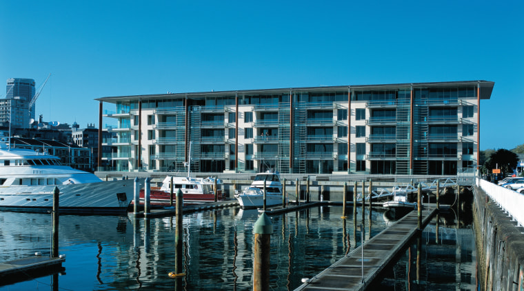 An exterior view of the lighter quay apartment architecture, building, city, condominium, corporate headquarters, dock, harbor, marina, mixed use, real estate, reflection, sky, water, water transportation, waterway, teal