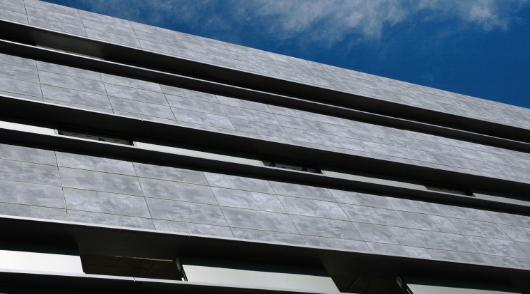 A view of the exterior of the building angle, architecture, building, cloud, daylighting, daytime, facade, line, roof, sky, steel, structure, gray, black