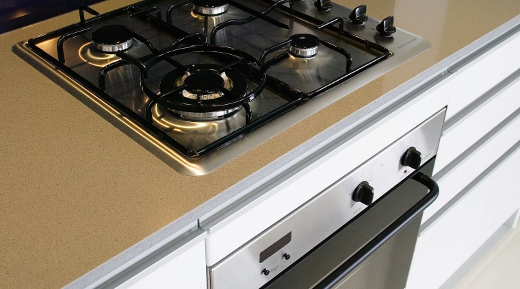 A view of this kitchen featuring the latest countertop, furniture, gas stove, home appliance, kitchen, kitchen stove, major appliance, product design, table, white