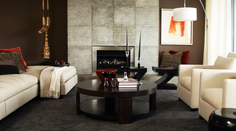 A view inside this sub-penthouse, contemporary elements, such coffee table, couch, floor, flooring, furniture, hearth, home, interior design, living room, loveseat, room, table, wall, black, white