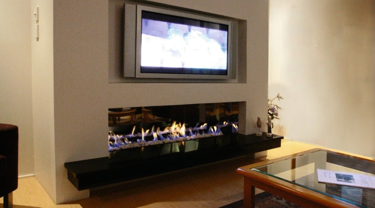 A view of a fireplace from Living Flame. ceiling, floor, flooring, home, house, interior design, living room, room, table, brown