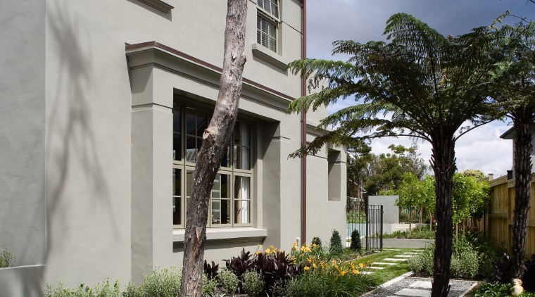 A view of a home designed by Town architecture, building, cottage, estate, facade, home, house, neighbourhood, property, real estate, residential area, sky, tree, villa, walkway, window, gray