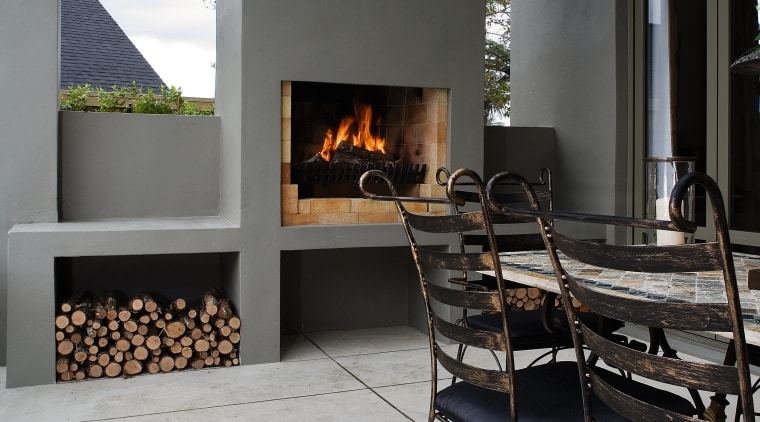 A view of some coloured concrete flooring by fireplace, floor, hearth, interior design, patio, gray, black