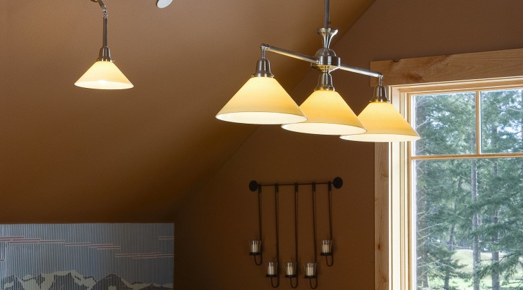 A view of the hang down lighting fixtures ceiling, chandelier, dining room, home, interior design, lamp, light fixture, lighting, lighting accessory, table, wall, brown