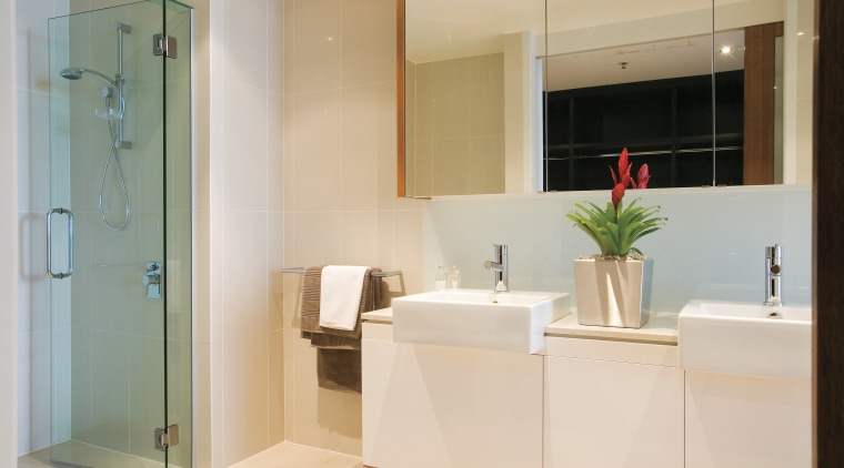 A view of the bathroom featuring tiled walls/flooring, bathroom, bathroom accessory, floor, home, interior design, room, gray