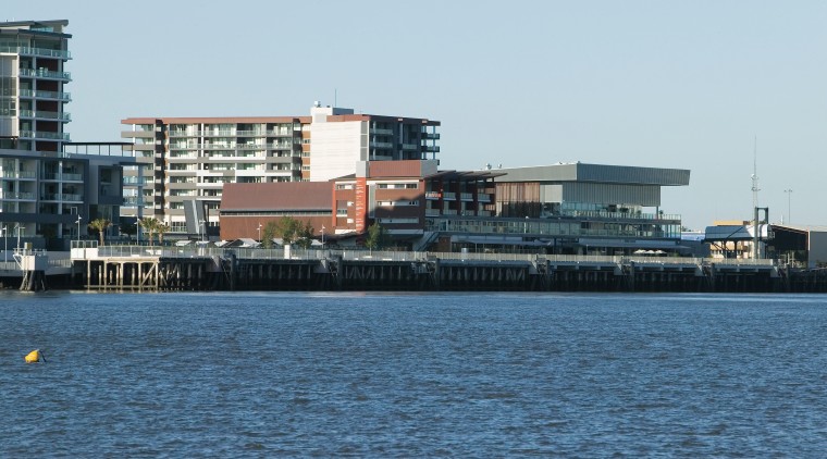 An exterior view of the Portside Wharf Apartment building, channel, city, condominium, port, sea, ship, sky, urban area, water, water transportation, waterway, white, teal