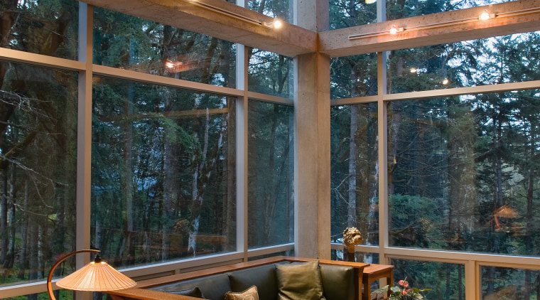 An interior view of the living area feautirng architecture, daylighting, deck, home, house, interior design, living room, outdoor structure, patio, table, window, wood, brown, black