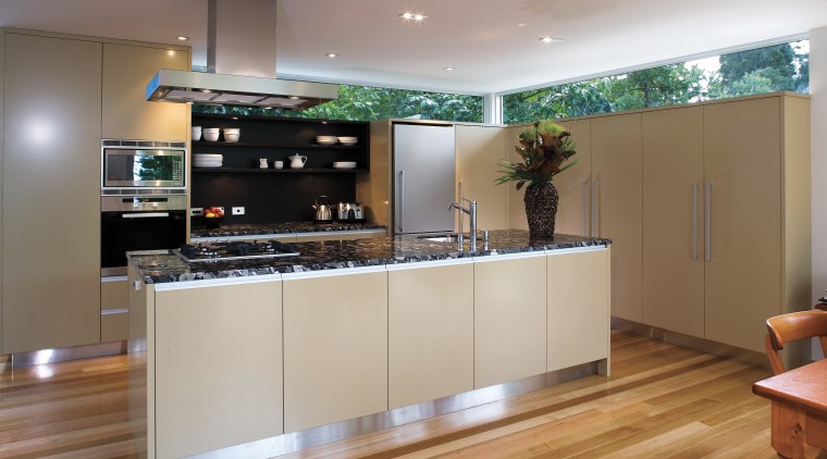 A view of this kitchen featuring polished timber cabinetry, countertop, interior design, kitchen, gray, brown