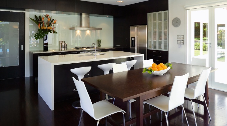 This contemporary kitchen incorporates plenty of storage, including countertop, dining room, interior design, kitchen, real estate, room, table, black, gray
