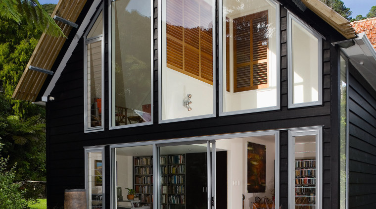 Previously, this home had minimal windows on its cottage, facade, home, house, real estate, siding, window
