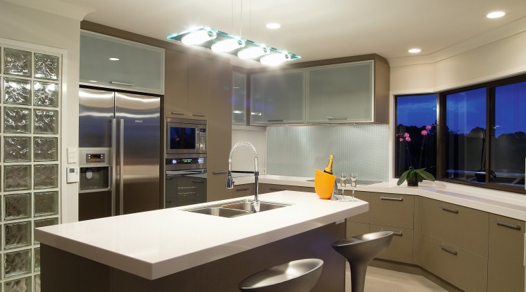 A view of this modern contemporary designed kitchens cabinetry, countertop, interior design, kitchen, real estate, room, gray