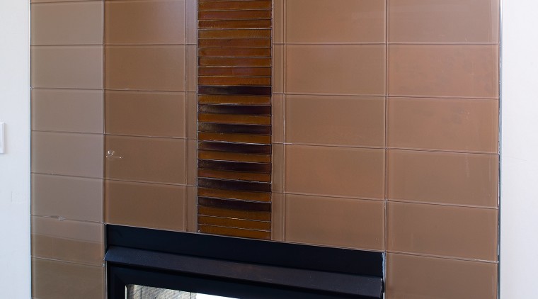 Glaas tiles were laid horizontally to create an fireplace, flooring, hearth, interior design, brown