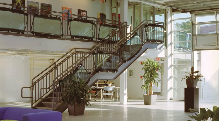 A large roller door on the south facade handrail, interior design, lobby, stairs, structure, gray, brown