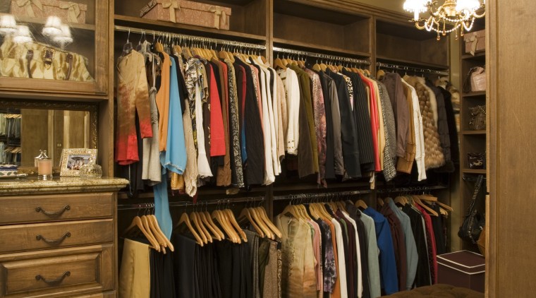 A view of the walk in wardrom accessed boutique, closet, furniture, interior design, room, brown, orange
