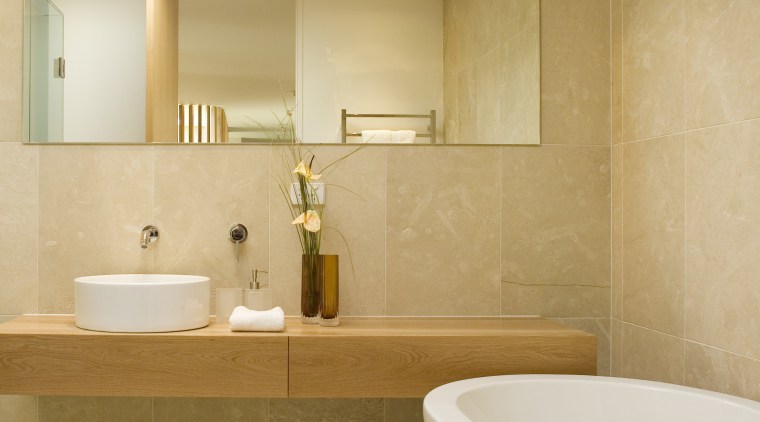 The vanity shelf is cantilevered, for an open, architecture, bathroom, bathroom sink, ceiling, ceramic, floor, flooring, home, interior design, plumbing fixture, product design, room, sink, tap, tile, wall, orange