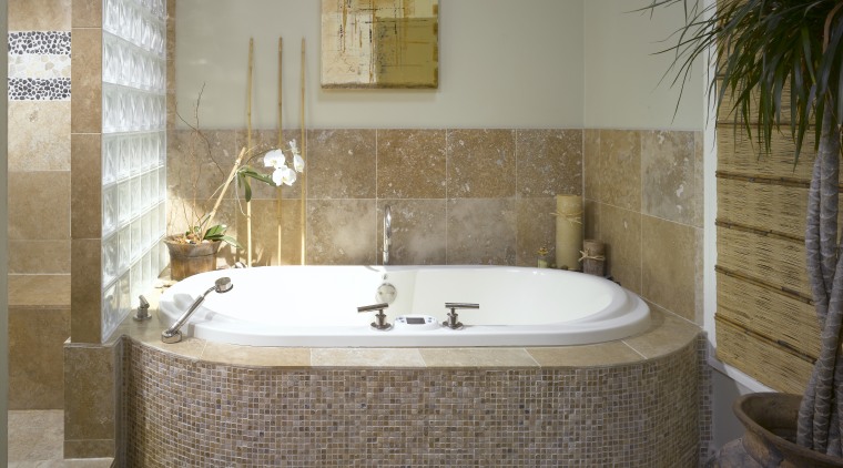 Small travertine tiles on the front of the bathroom, bathtub, floor, flooring, interior design, plumbing fixture, room, tile, wall, brown, gray